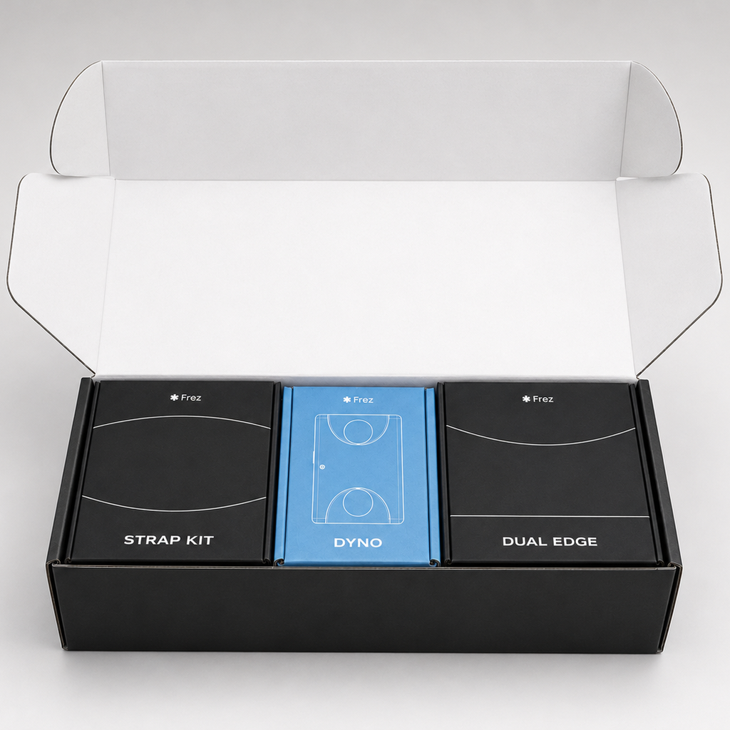 Open black box containing 'STRAP KIT', 'DYNO', and 'DUAL EDGE' items on a white background