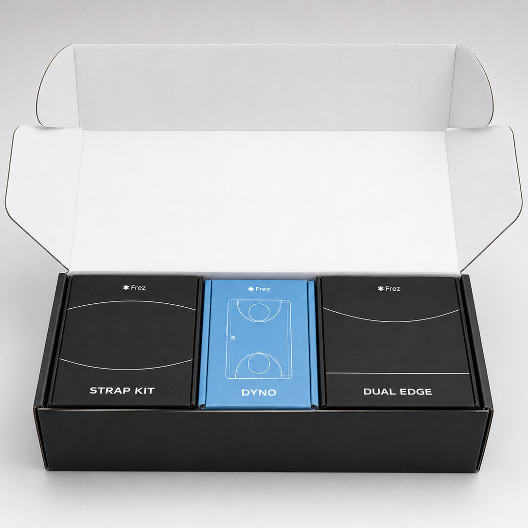 Open black box containing 'STRAP KIT', 'DYNO', and 'DUAL EDGE' items on a white background