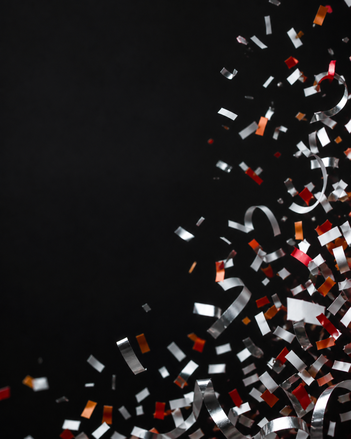 White, silver, red, and orange confetti on black